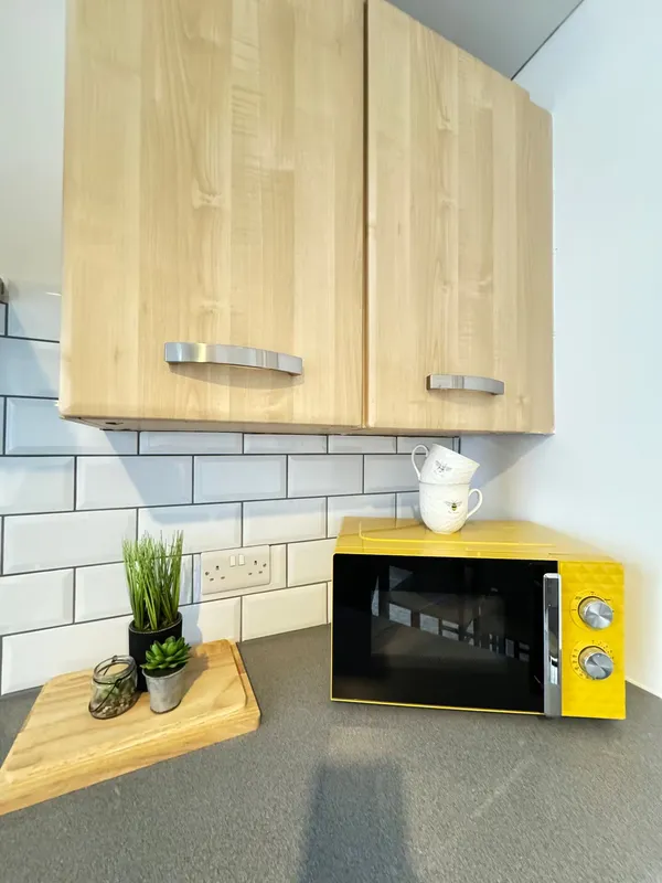 Kitchen with microwave and plant at the Barnsley home