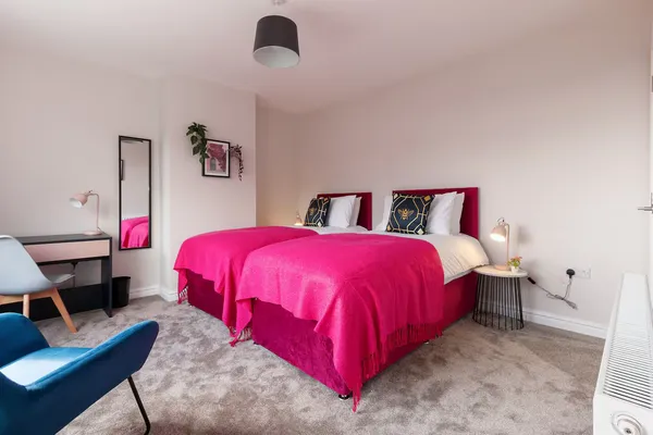 King-size bedroom with pink throw at the Sheffield family home