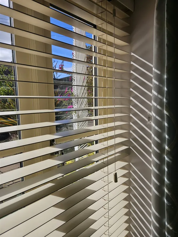 Close-up of cream real wood venetian blind slats fitted by Eclipse SBC in Woodhall Spa
