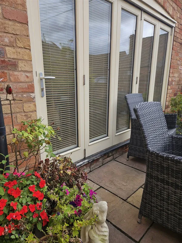 Bi-fold doors with Fit to Frame wood venetian blinds seen from the patio, fitted by Eclipse SBC in Woodhall Spa