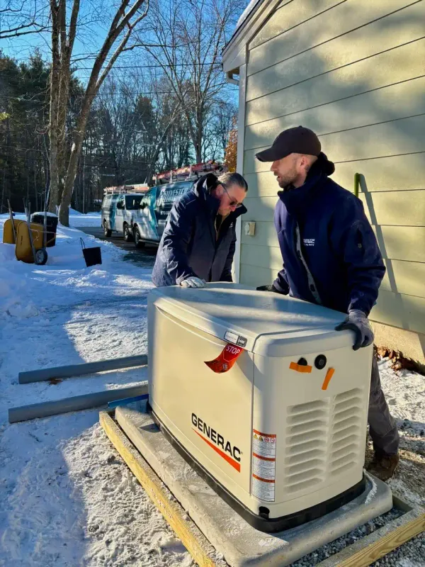 Sylvester Electric team positioning a Generac standby generator beside a home