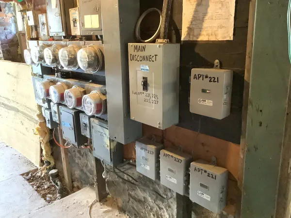 Before: indoor multi-meter equipment mounted on an older wall