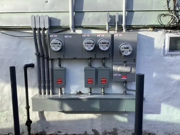 After: exterior meter bank and service disconnects
