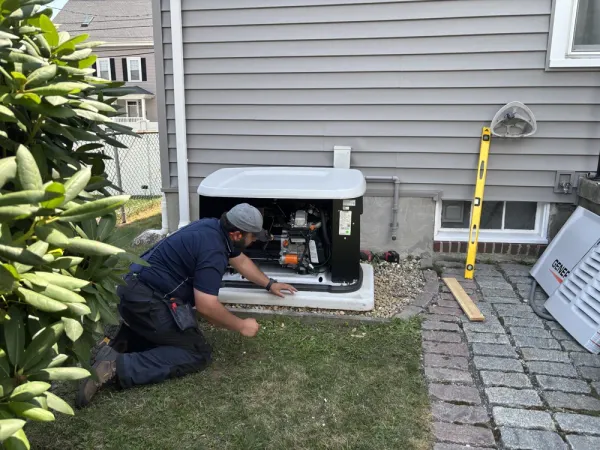 Sylvester Electric technician working on an outdoor Generac standby generator