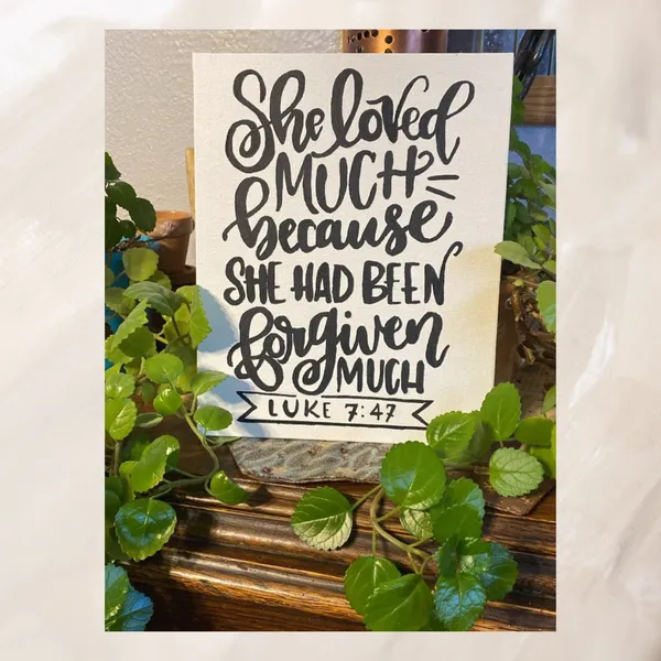 Student's hand lettered sign displayed with greenery