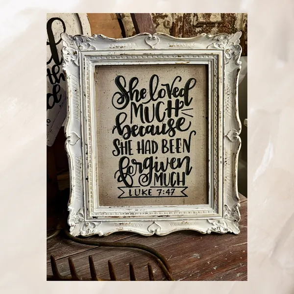 Student's hand lettered sign in an ornate white frame