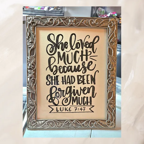 Student's hand lettered sign in an ornate gold frame