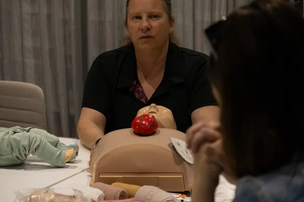 Britt Brennan explaining a CPR step to a student