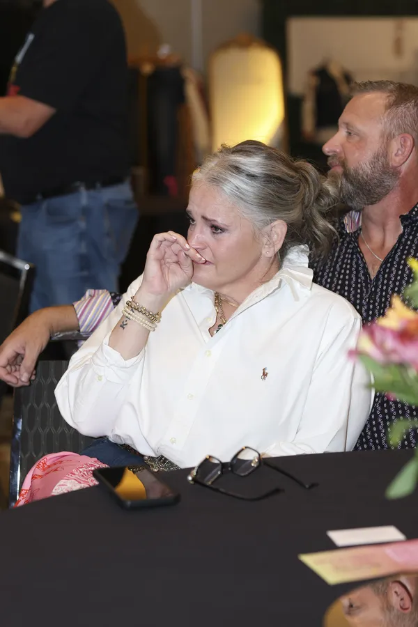 A woman moved to tears during a heartfelt moment at a gathering