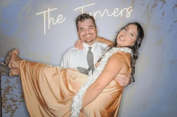 Happy couple posing together at their wedding Photo-N-Go experience