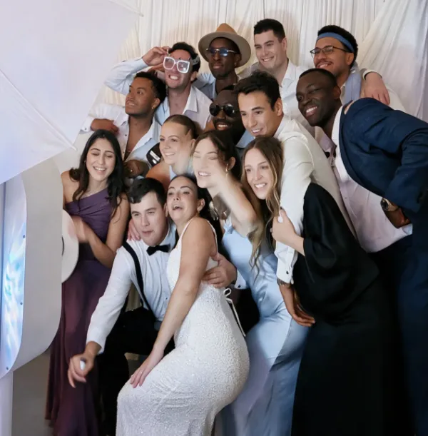 Large group of wedding party guests laughing together at a Photo-N-Go photo booth