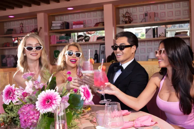 Friends toasting cocktails at a luxury Long Beach event