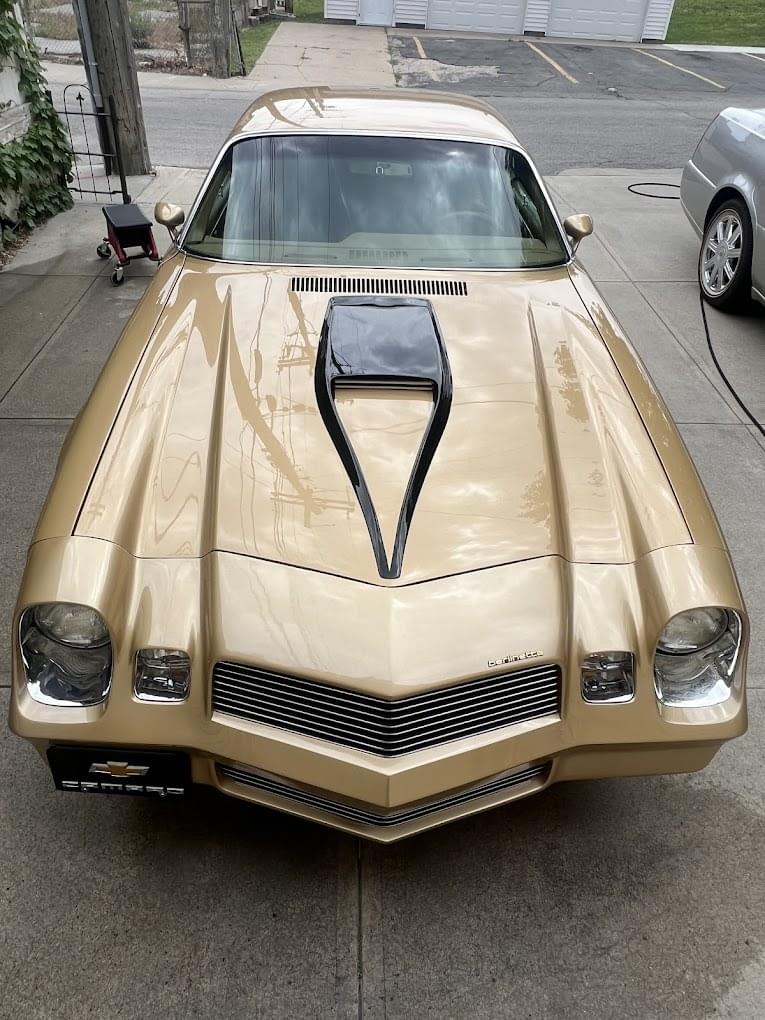 Gold classic Chevy Camaro after paint polishing by Invictus Mobile Auto Care in an Omaha NE driveway