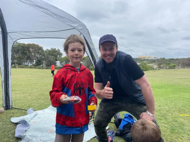 Jaydon with a young guest at a Fun in Faith party