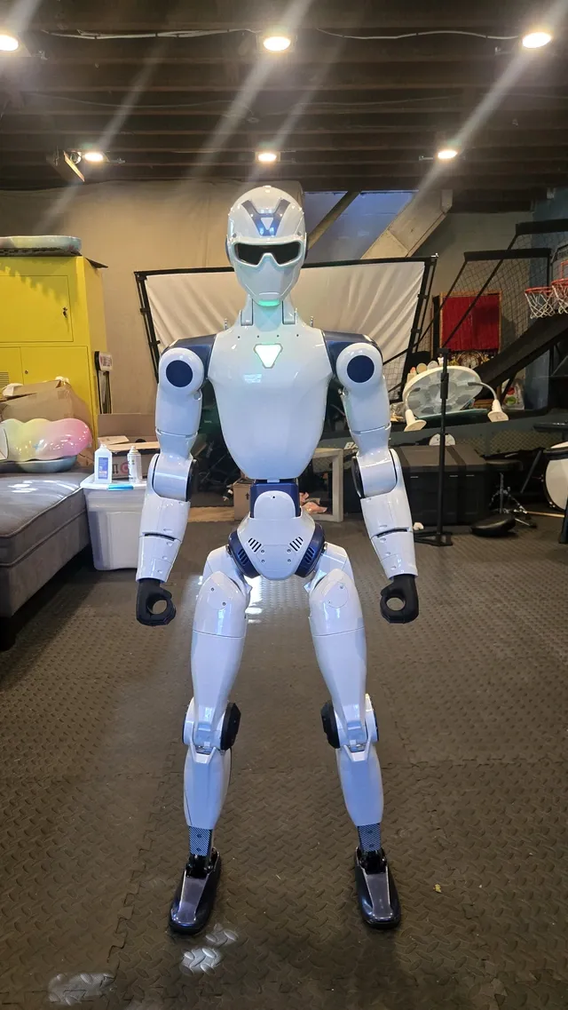 Ted, the Unitree R1 EDU held by EZ Robot Rentals, standing indoors.