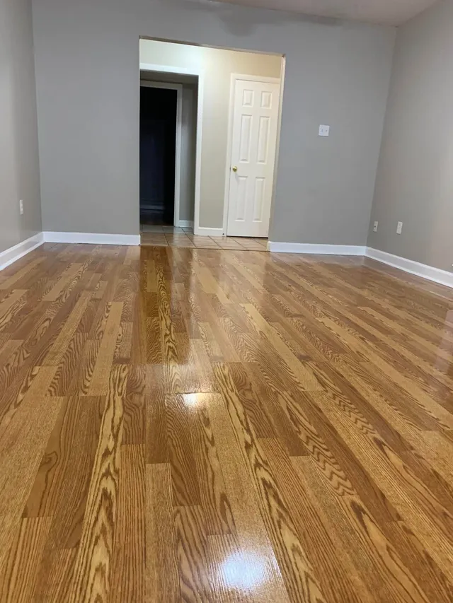 Glossy wood floors in an empty room mopped by Pretty in Pink Cleaning Service in Wetumpka, AL