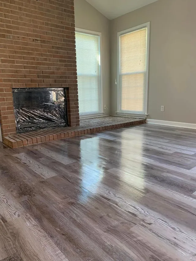 Fireplace room with freshly mopped plank floors cleaned by Pretty in Pink Cleaning Service near Eclectic, AL