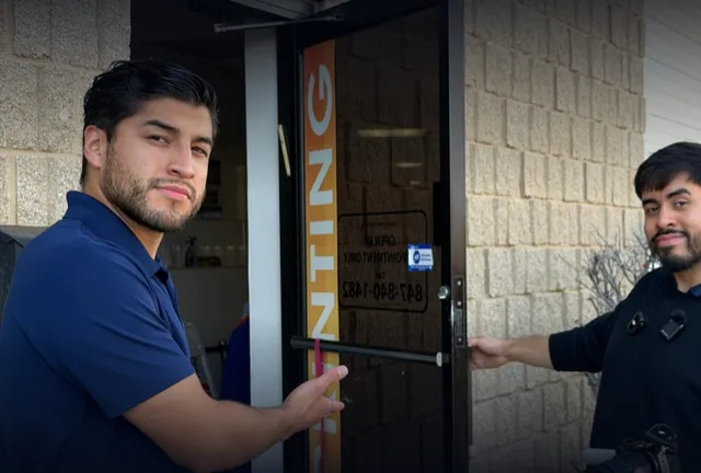Angel and Cesar from VELPI at the door of a local business