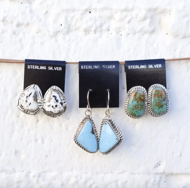 Three pairs of sterling silver earrings with white, blue and green stones