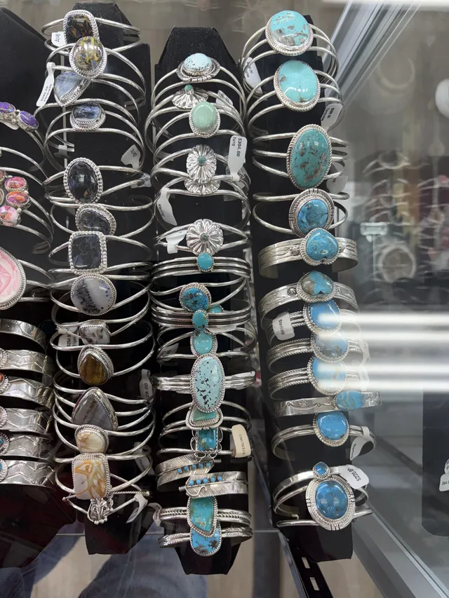 A case of sterling silver cuff bracelets with turquoise and other stones