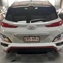 A white hyundai kona is parked in a garage - window tinting by Tint Wright Brisbane