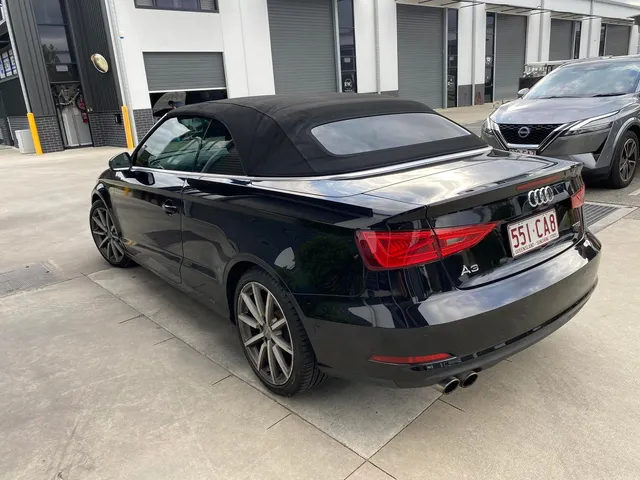 A black audi a3 convertible is parked in a parking lot - window tinting by Tint Wright Brisbane