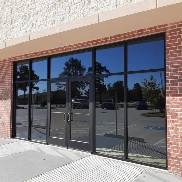 A building with a lot of windows and a brick wall - window tinting by Tint Wright Brisbane