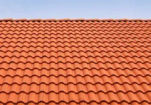 Orange clay tile roof against a blue sky
