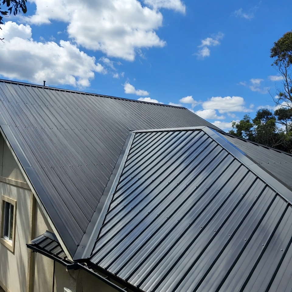 Dark standing seam metal roof on a two-story home