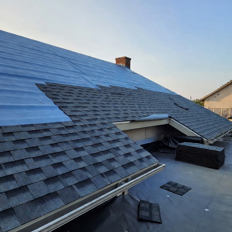 New shingles going on over underlayment during a shingle roof installation