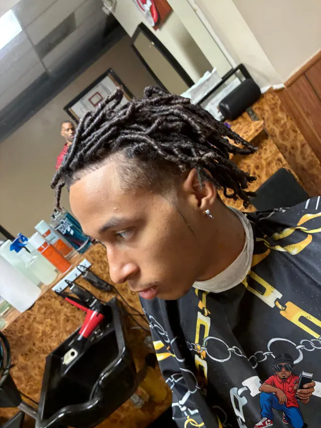 Freshly retwisted locs with a clean taper