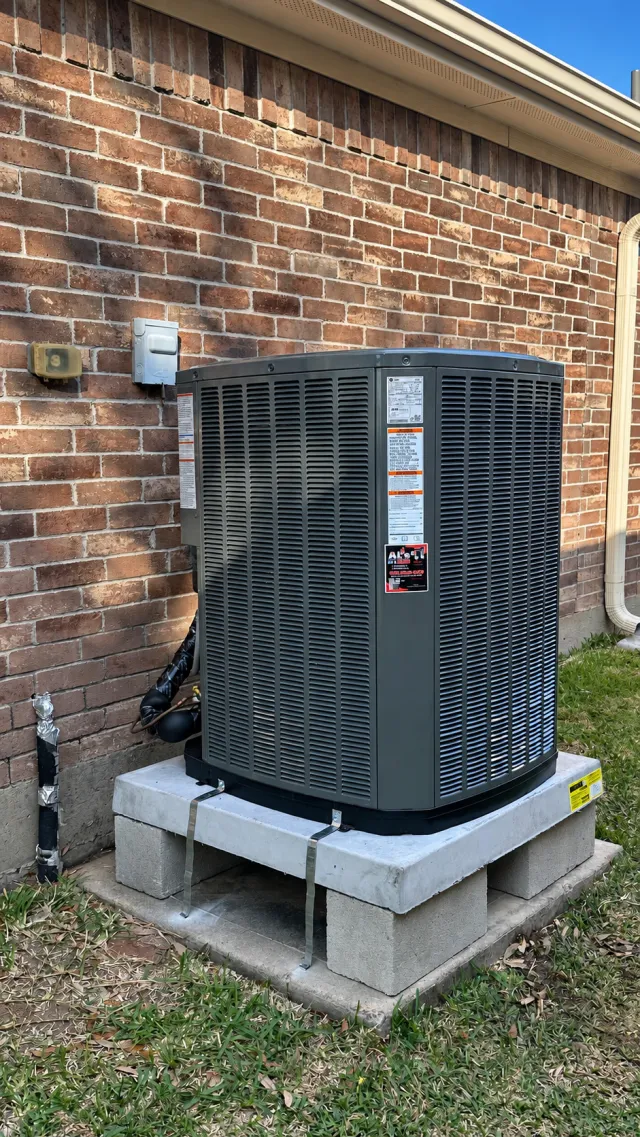 Outdoor condenser secured to a raised equipment pad