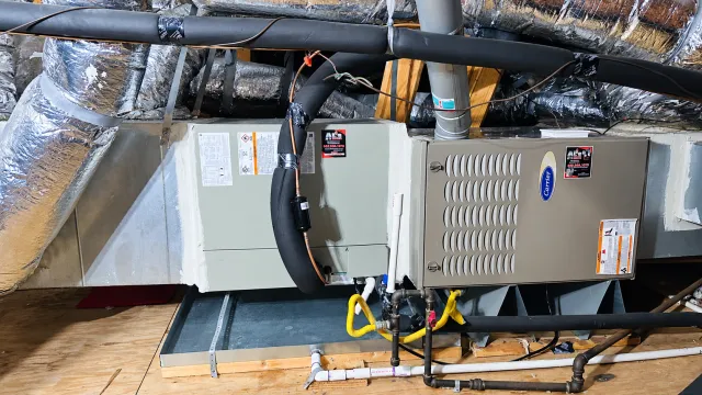 Carrier attic furnace with connected ductwork and drain pan