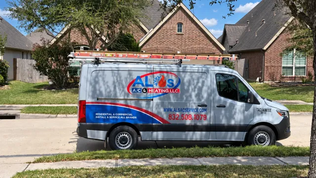 Al’s AC & Heating branded service van outside a Houston-area home