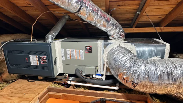 Attic furnace and evaporator assembly connected to insulated air ducts