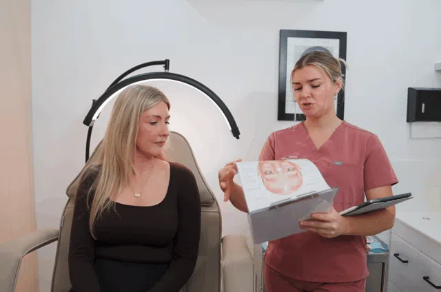 Kirra explaining a facial assessment during a consultation