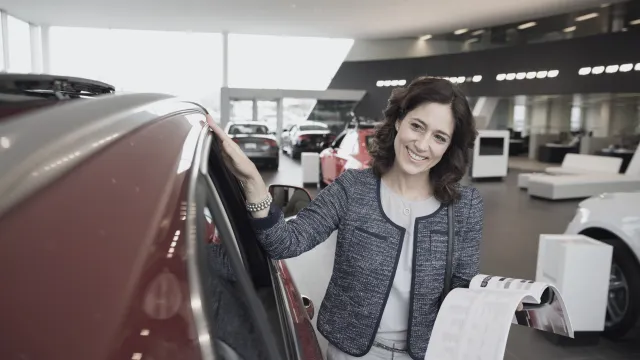 A customer considering a vehicle in a real showroom