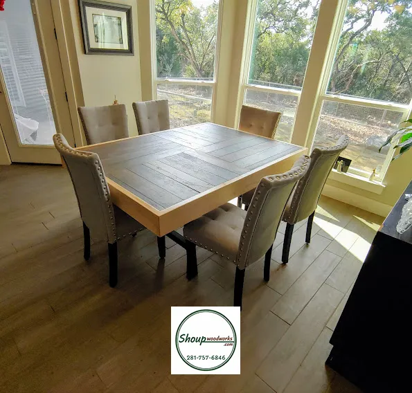 Custom rectangular wood dining table with upholstered chairs in a Houston breakfast room, by Shoup Woodworks