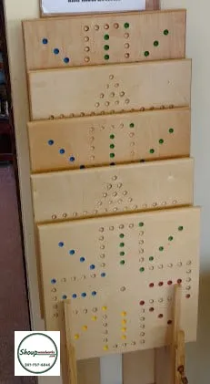 Stack of finished wooden Wahoo game boards at Shoup Woodworks in Houston