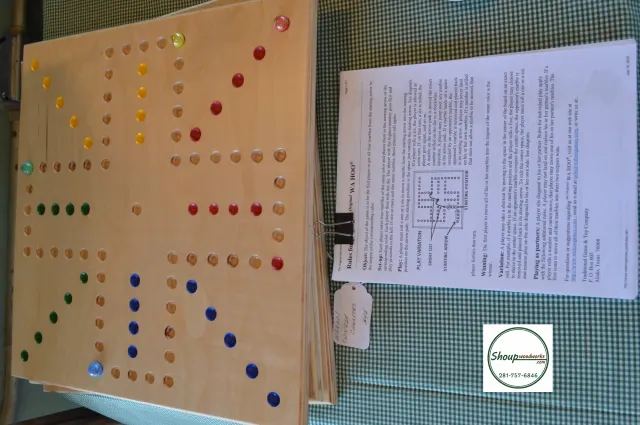 Wooden Wahoo board shown with printed game rules, handcrafted in Houston by Shoup Woodworks