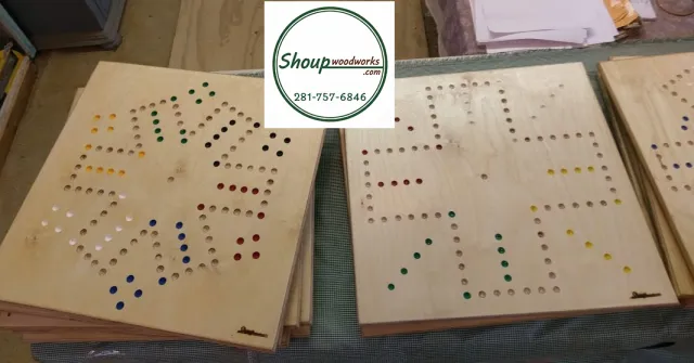 Several six-player wooden Wahoo boards handcrafted in Houston by Shoup Woodworks