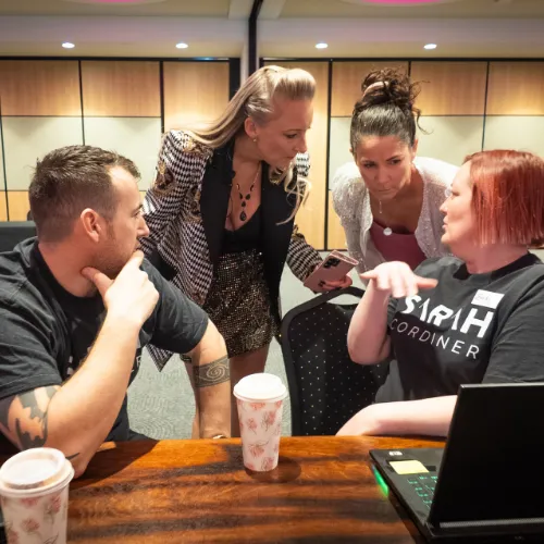 Sarah Cordiner helping attendees one-on-one during a workshop