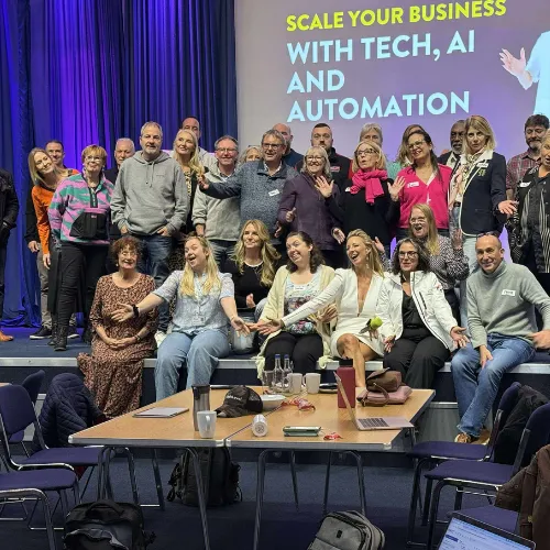 Group photo of workshop attendees under a Scale Your Business With Tech, AI and Automation banner