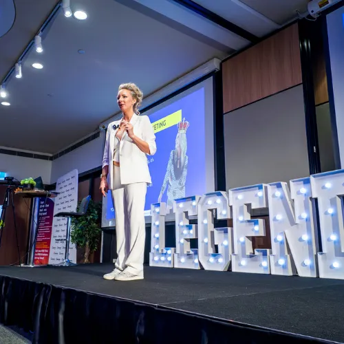 Sarah Cordiner on stage with LEGENDS light-up letters