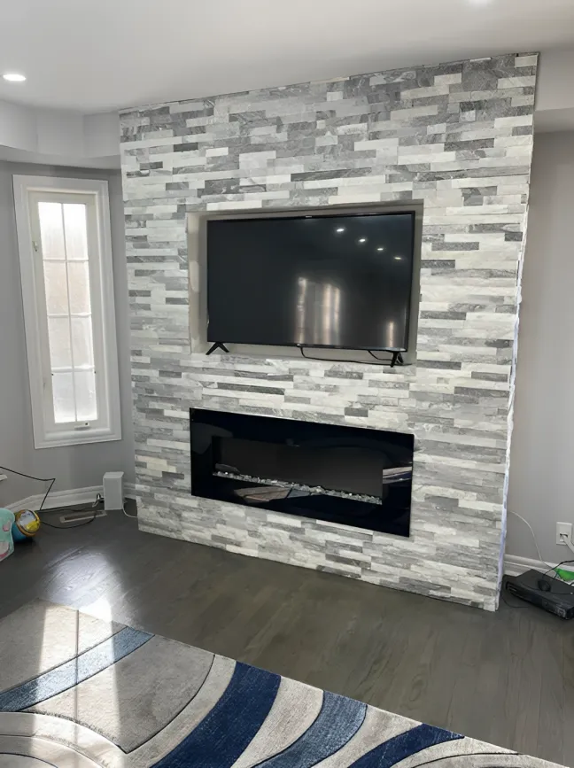 Stacked-stone fireplace feature wall with mounted television
