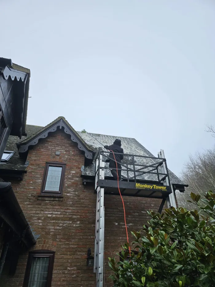 Roof being cleaned from a tower by AK Exterior Cleaning