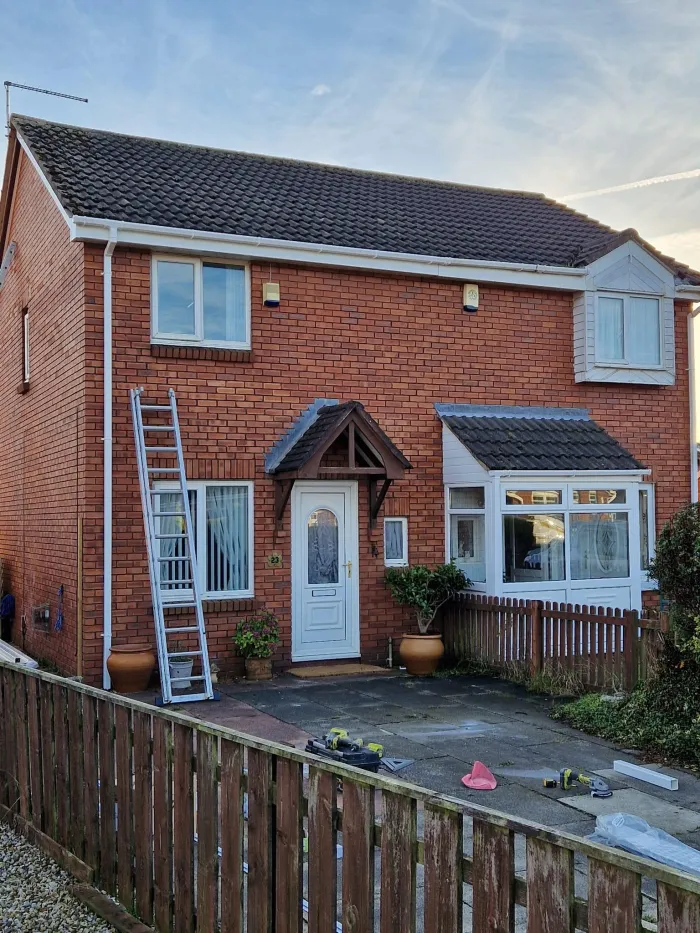 Semi-detached house roof being cleaned