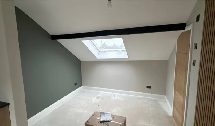 Loft conversion with rooflight and exposed beam
