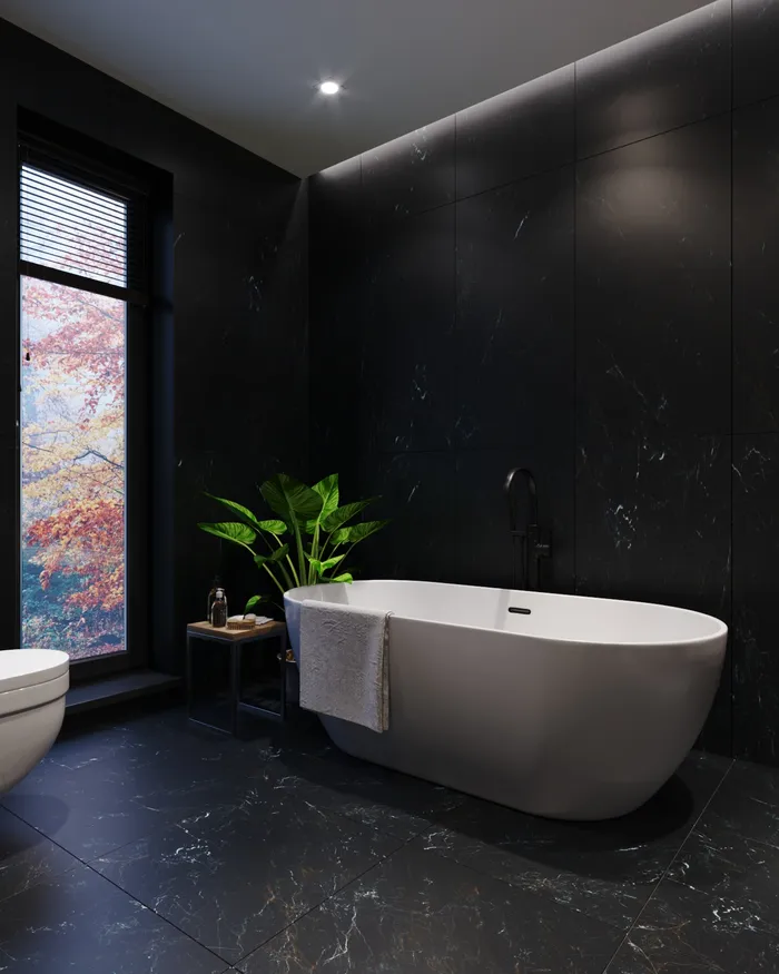 Dark-tiled bathroom with freestanding bath