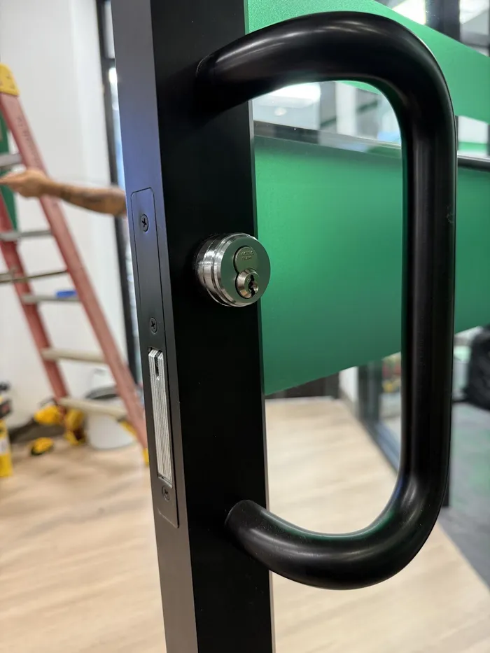 Storefront door pull with a key lock